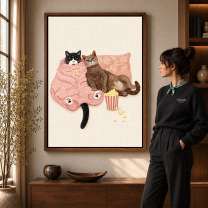 Cozy Movie Cats canvas art in a walnut frame beside a standing woman and wooden console.