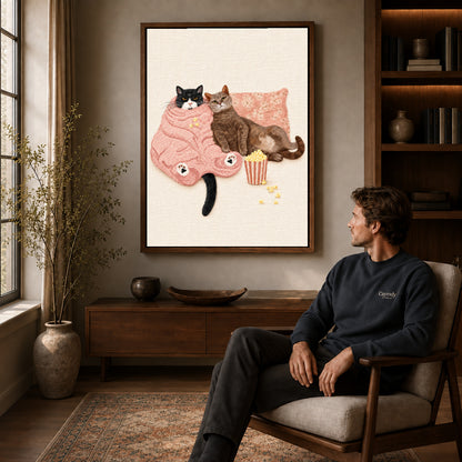 Cozy Movie Cats canvas art above a wooden console beside a seated man in a warm room.