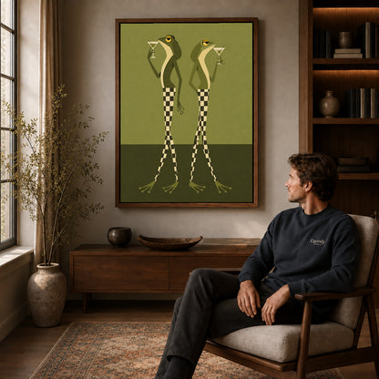 Martini Frogs canvas art above a wooden console beside a seated man in a warm room.