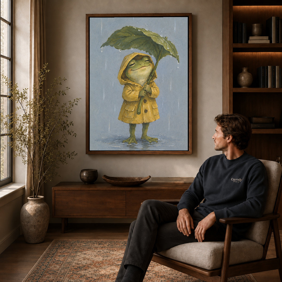 Raincoat Frog canvas art above a wooden console beside a seated man in a warm room.