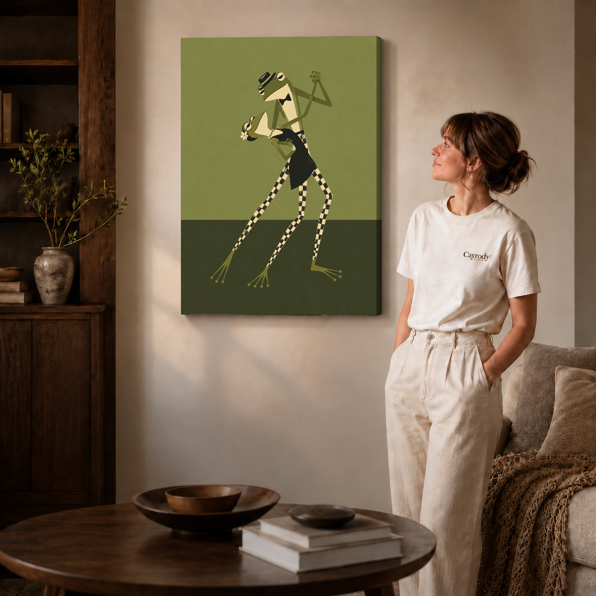 Dancing Frogs canvas art displayed as gallery wrapped canvas beside a woman in natural light.
