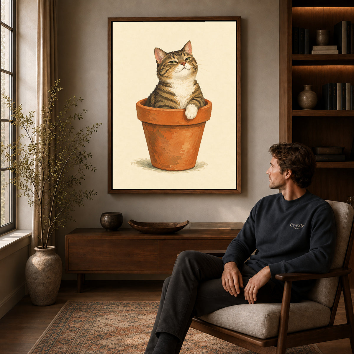 Flowerpot Cat canvas art above a wooden console beside a seated man in a warm room.
