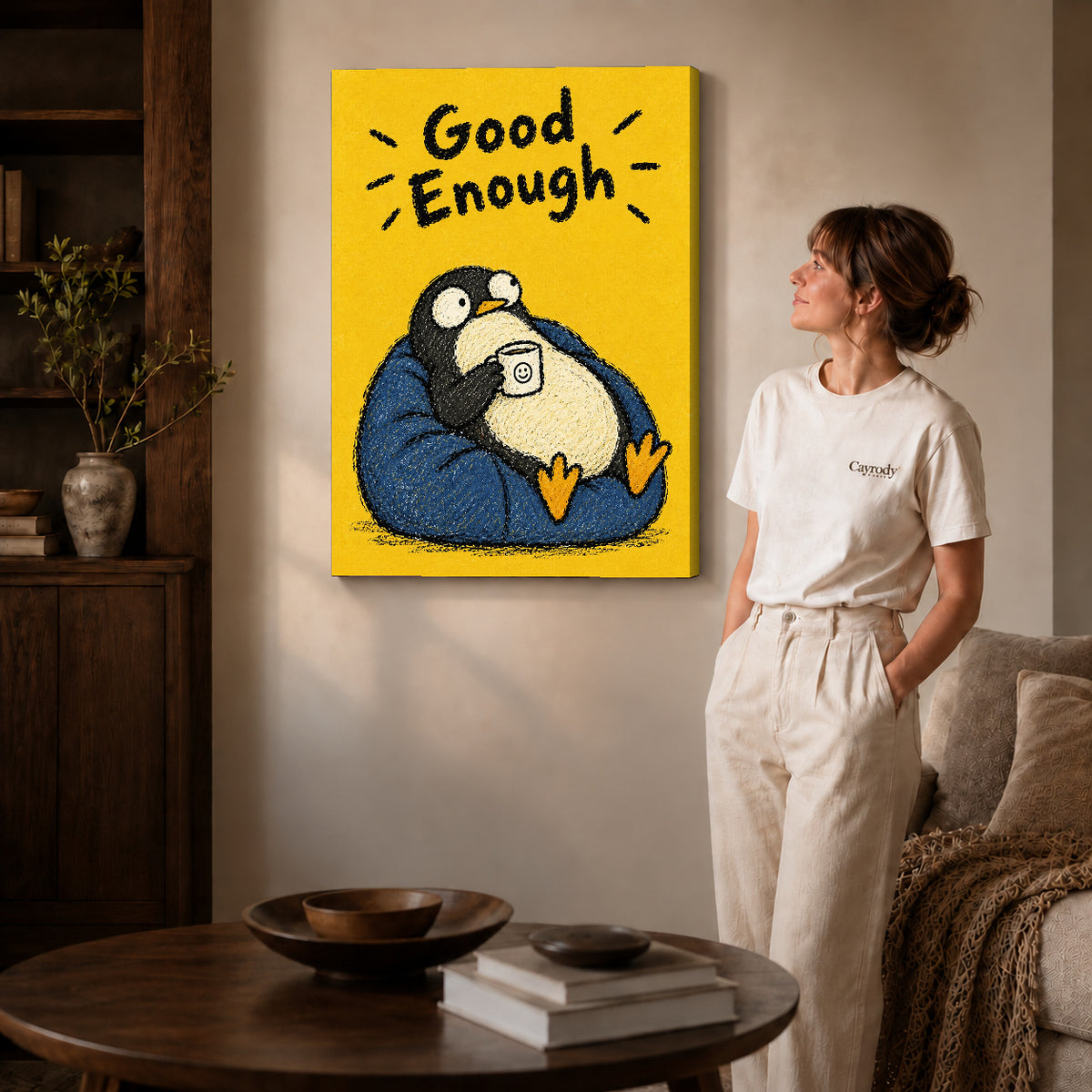 Resting Penguin canvas art displayed as gallery wrapped canvas beside a woman in natural light.