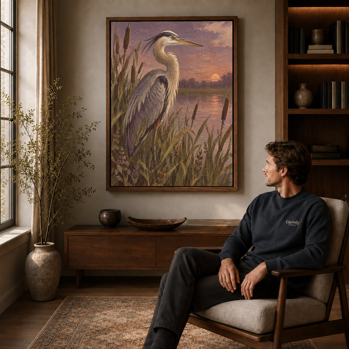 Marsh Heron canvas art above a wooden console beside a seated man in a warm room.