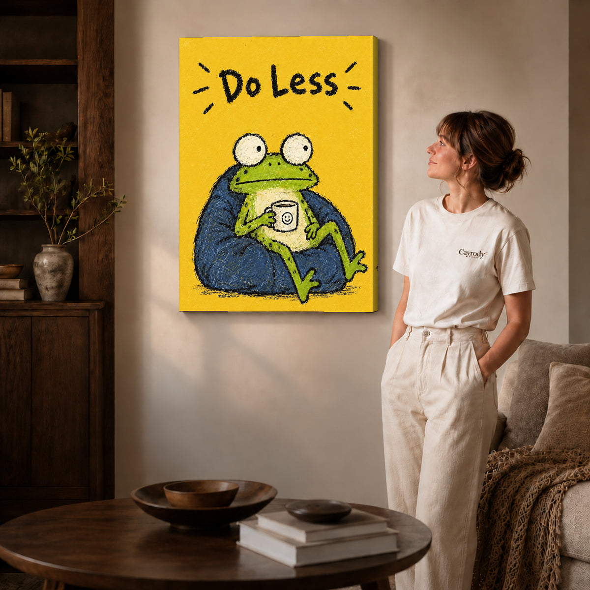 Resting Frog canvas art displayed as gallery wrapped canvas beside a woman in natural light.