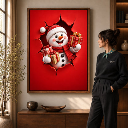 Gift Giving Snowman canvas art in a walnut frame beside a standing woman and wooden console.