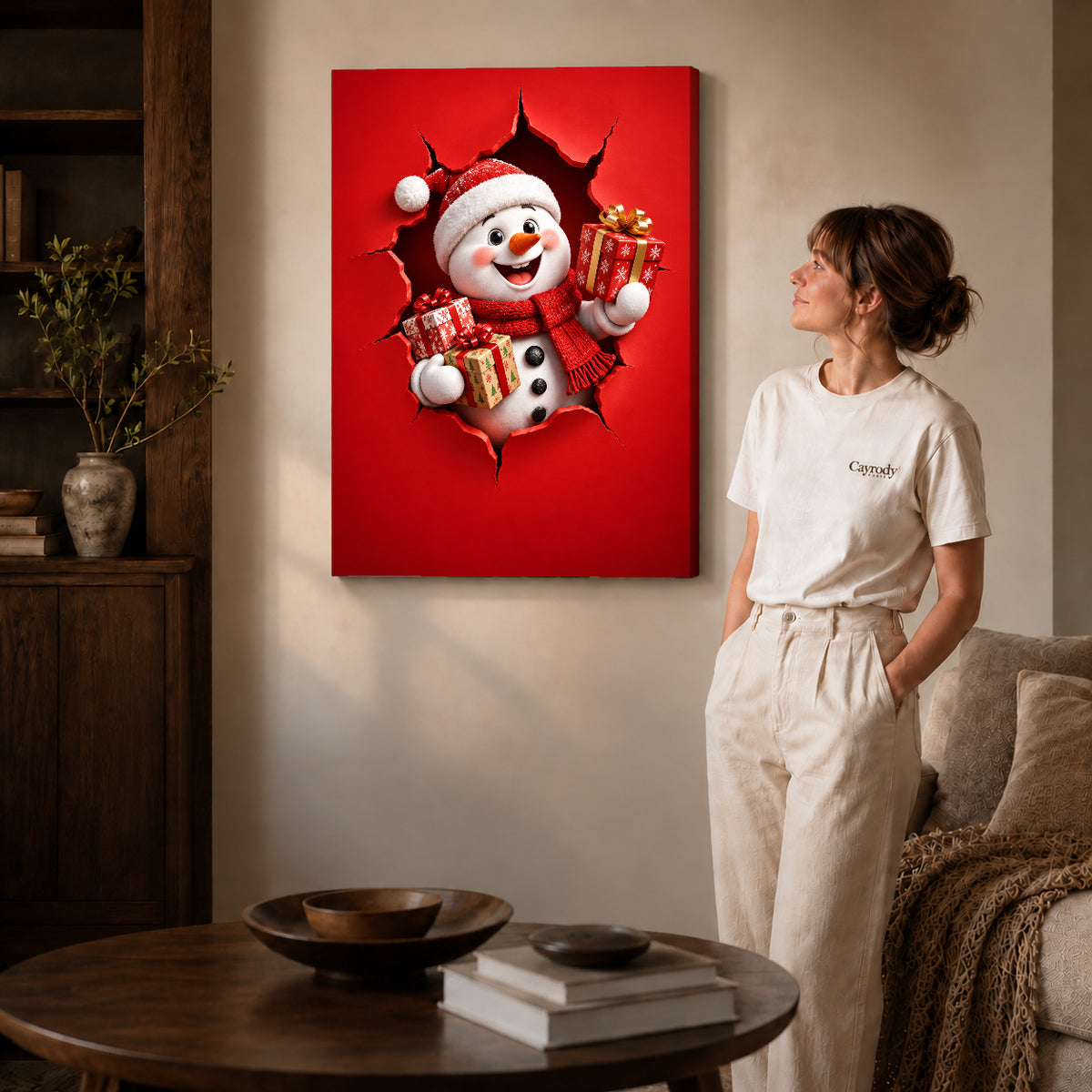Gift Giving Snowman canvas art displayed as gallery wrapped canvas beside a woman in natural light.