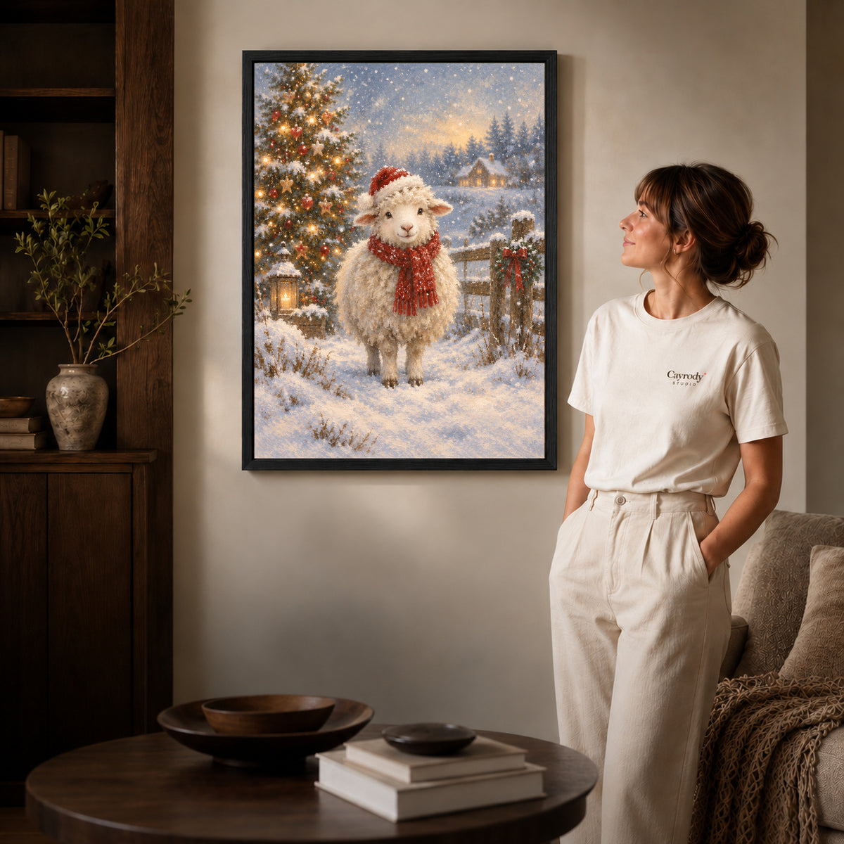 Black framed christmas lamb canvas art displayed beside a woman in a warm living room.