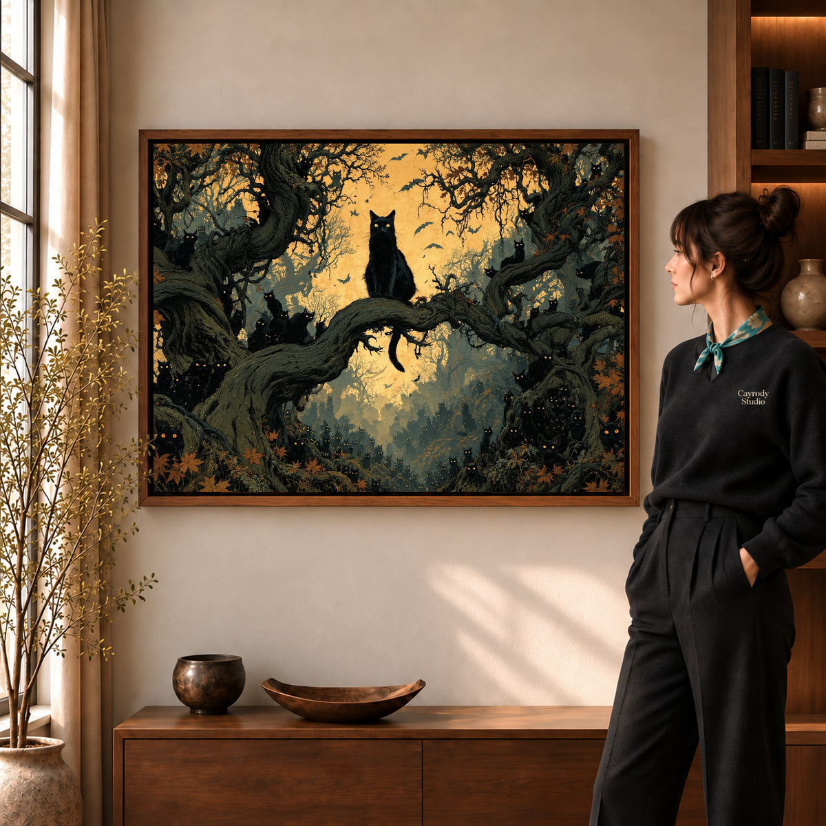 Walnut framed enchanted cat forest canvas art shown beside a standing woman and a wooden console.