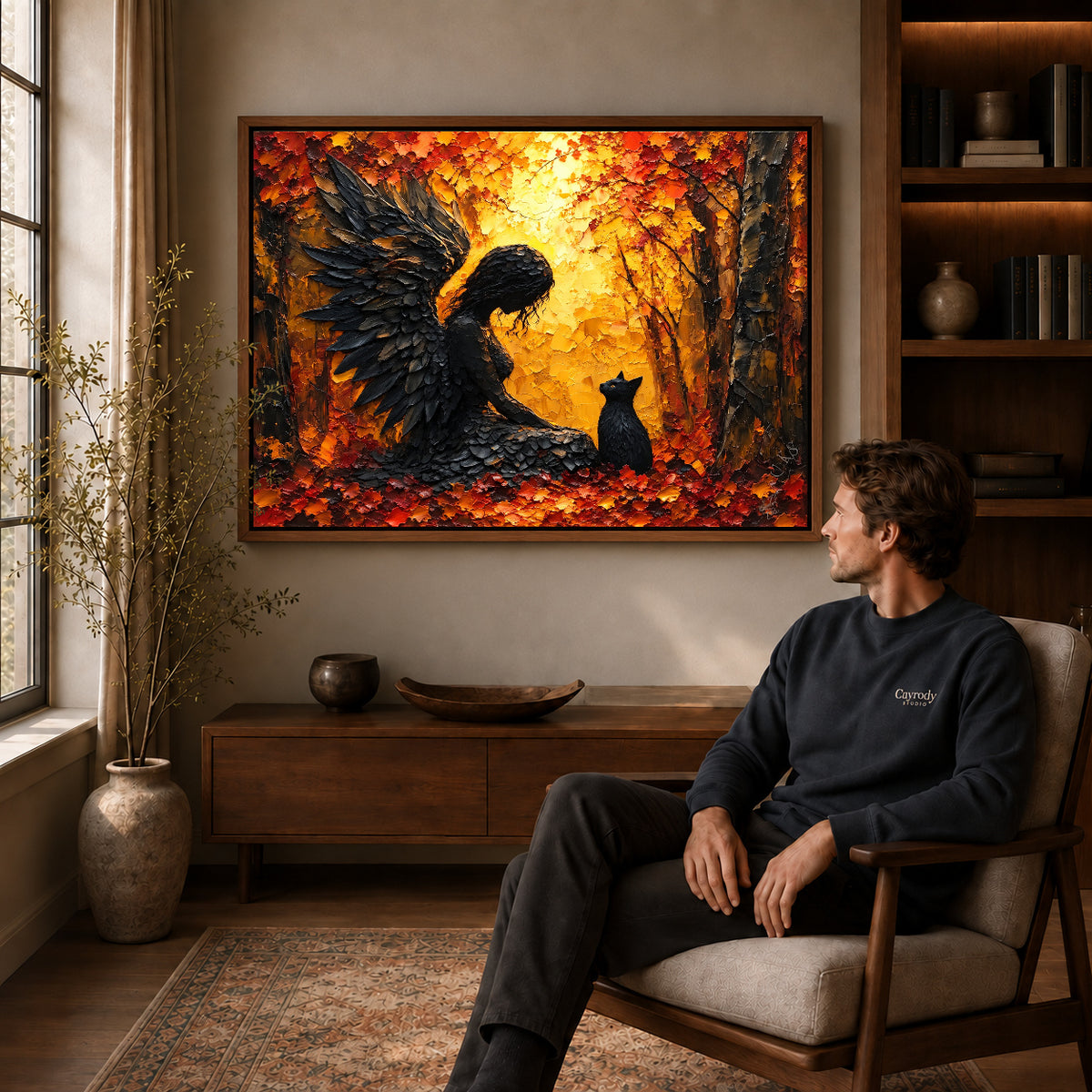 Feathered Guardian Cat canvas art above a wooden console beside a seated man in a warm room.