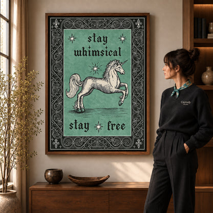 Free Spirit Unicorn canvas art in a walnut frame beside a standing woman and wooden console.