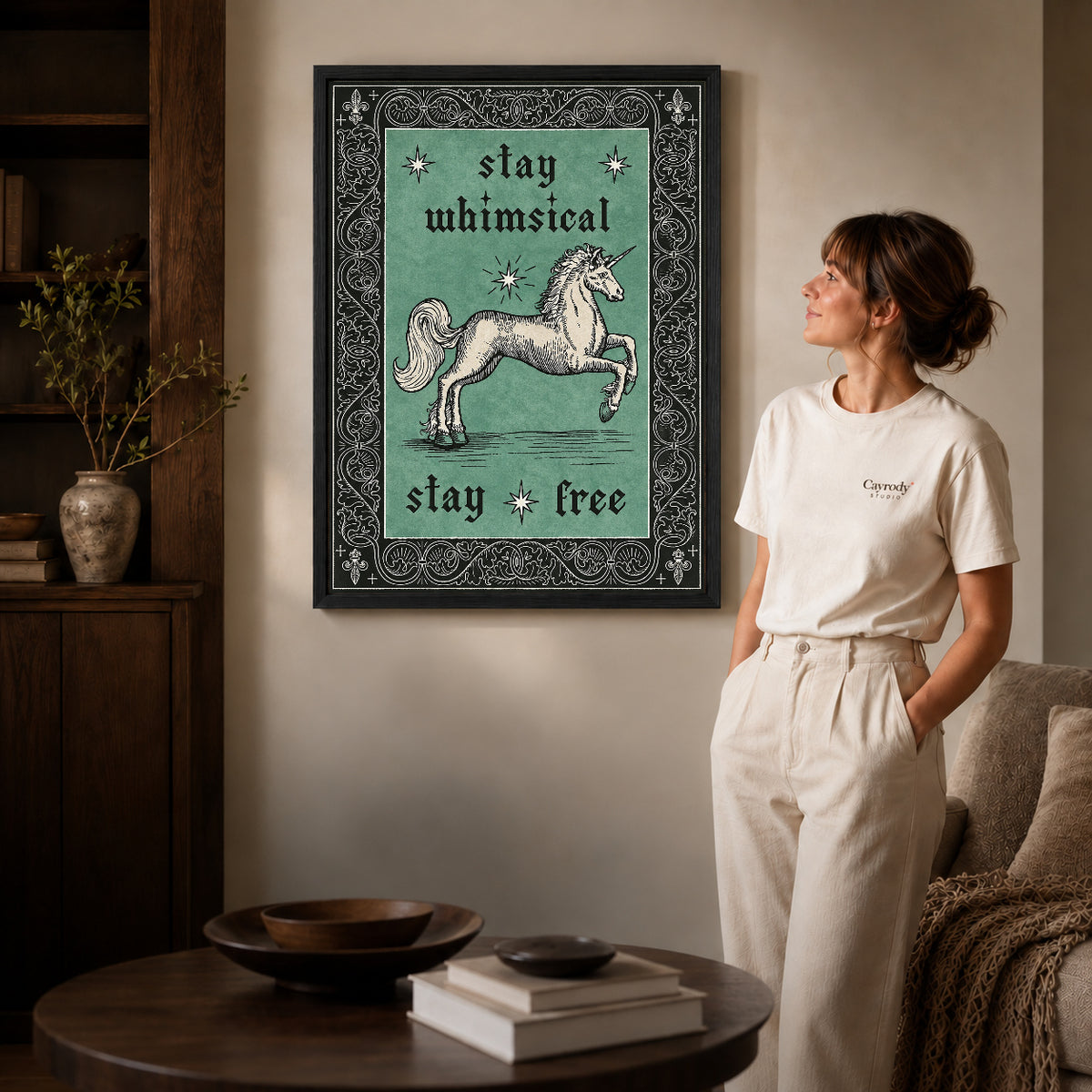 Free Spirit Unicorn canvas art in a black frame above books in a welcoming living room.