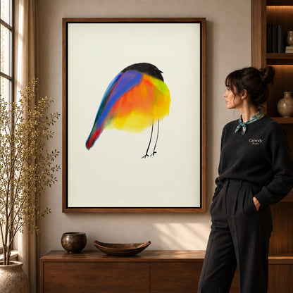 Colorful Bird canvas art in a walnut frame beside a standing woman and wooden console.