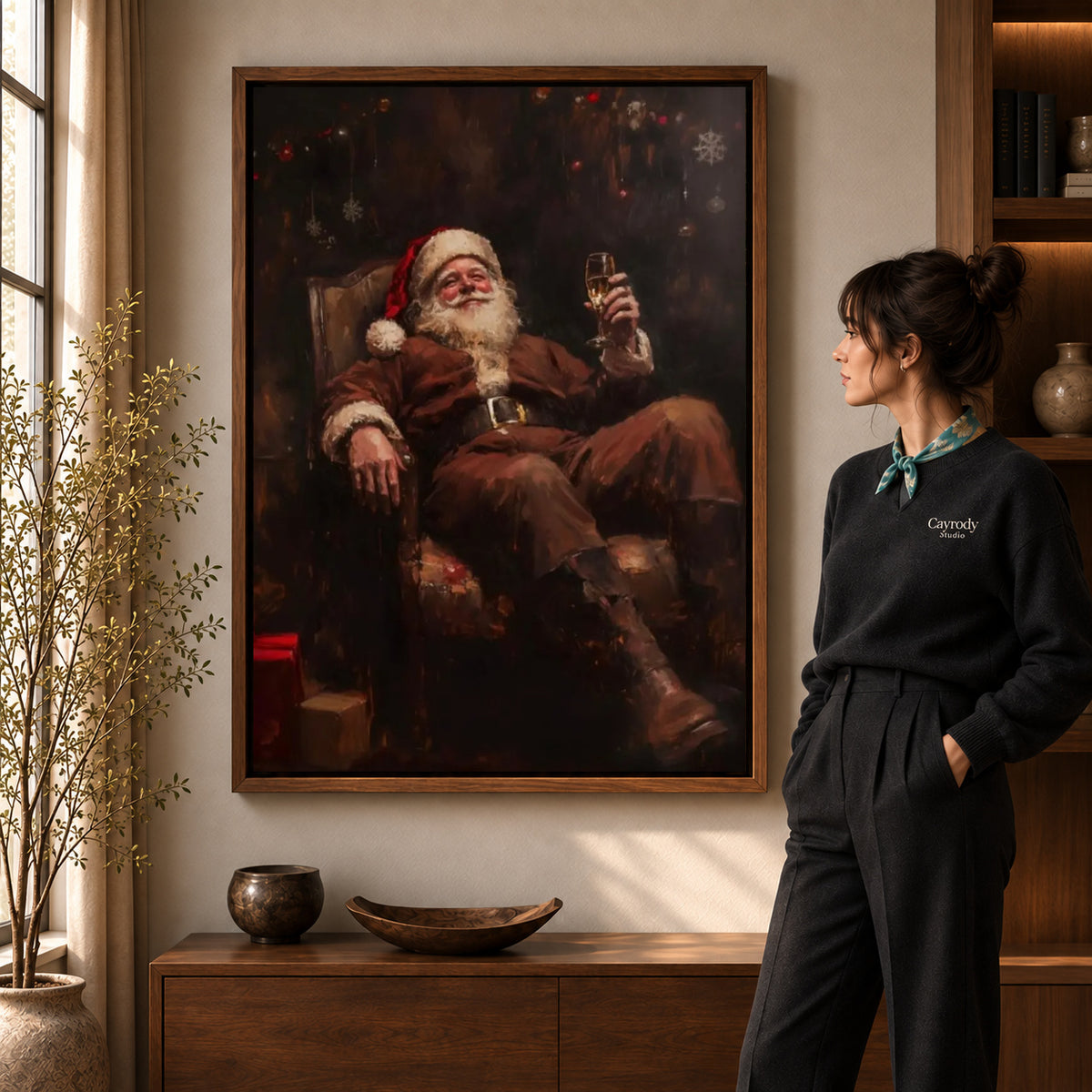 Walnut framed relaxing santa canvas art shown beside a standing woman and a wooden console.