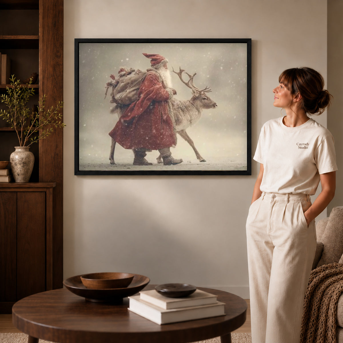 Santa Reindeer canvas art in a black frame above books in a welcoming living room.