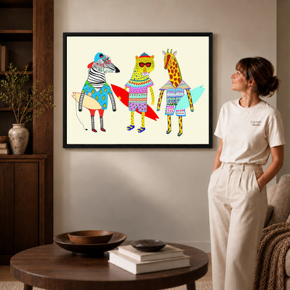 Black framed surfing animals canvas art displayed beside a woman in a warm living room.