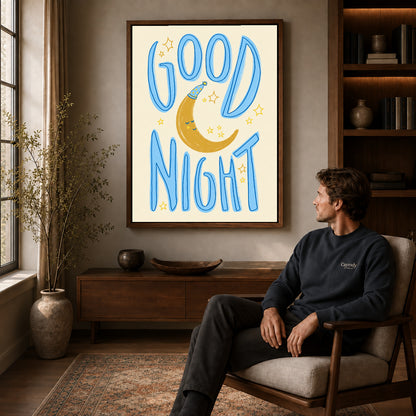 good night moon art canvas art in a walnut frame above a console beside a seated man.