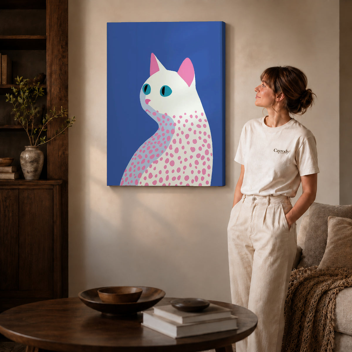 Gallery wrapped spotted cat canvas art with visible canvas edges beside a standing woman.