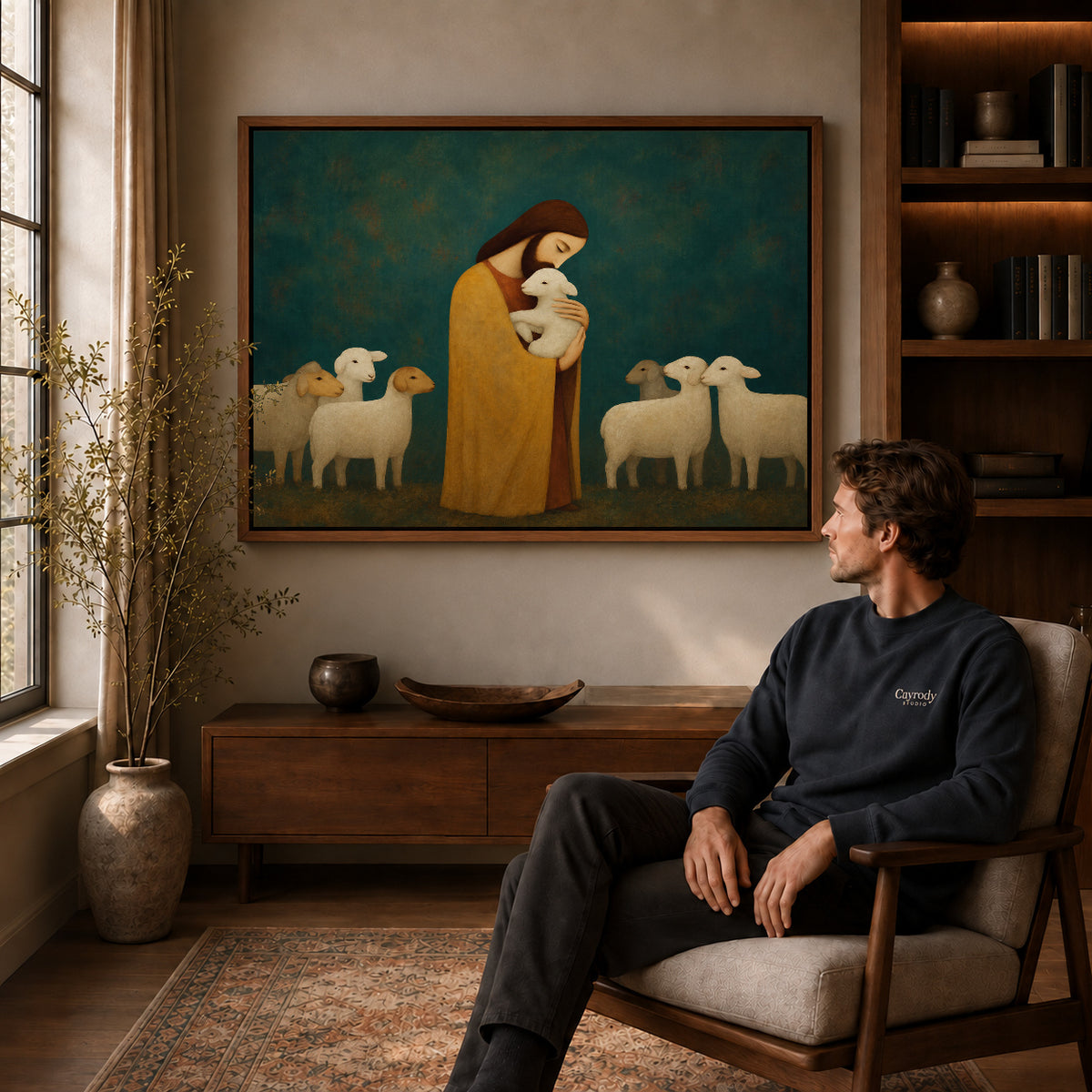Gentle Shepherd canvas art above a wooden console beside a seated man in a warm room.