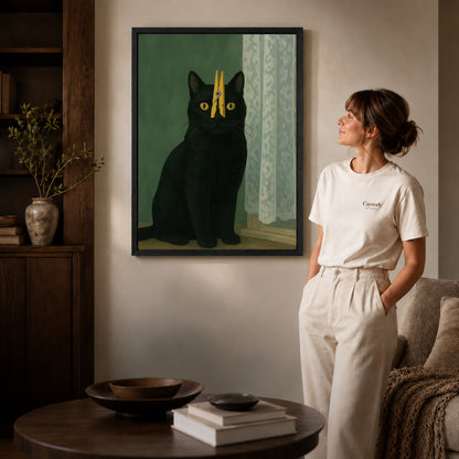 Clothespin Cat canvas art in a black frame above books in a welcoming living room.