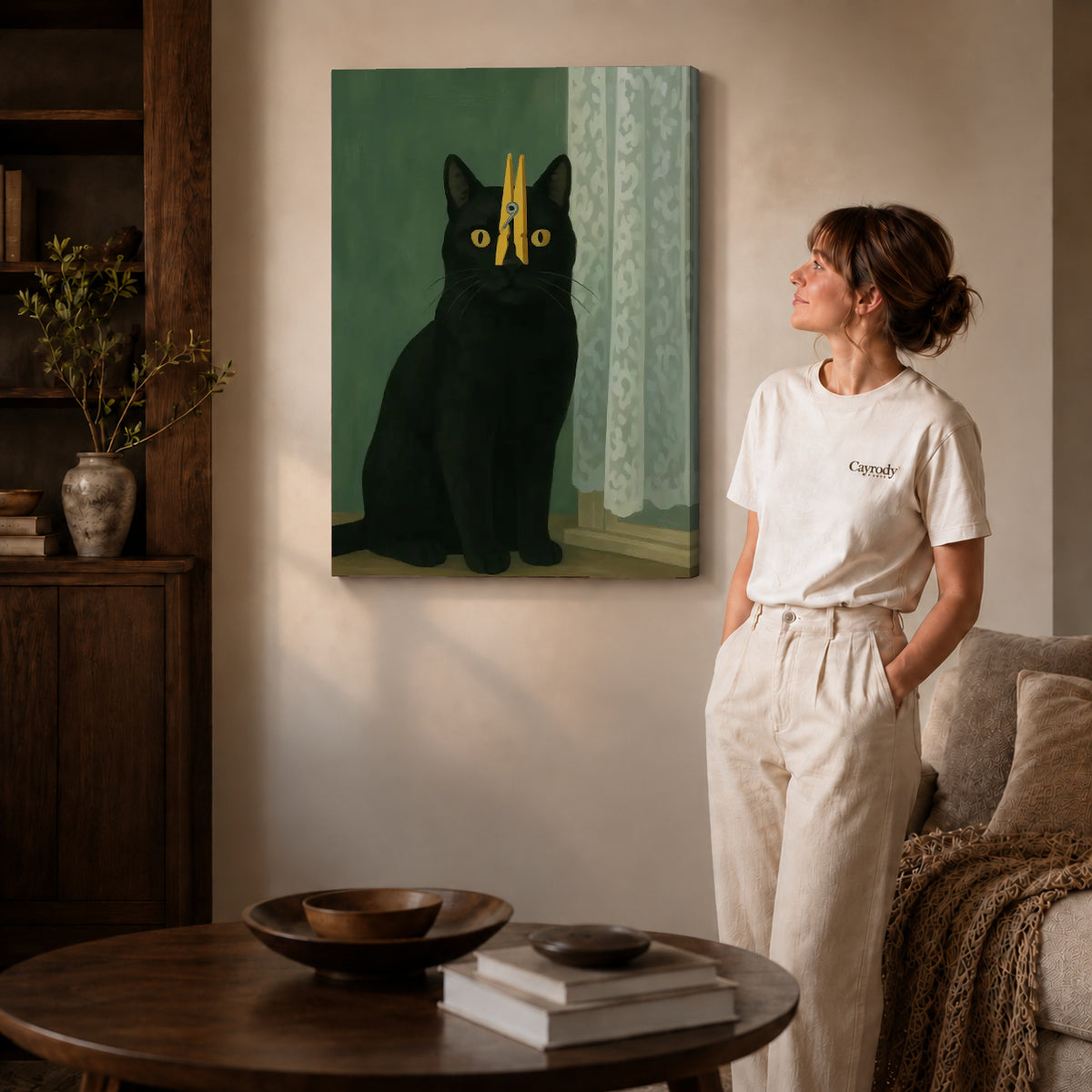 Gallery wrapped clothespin cat canvas art with visible canvas edges beside a standing woman.