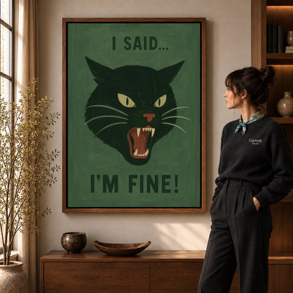 Grumpy Cat canvas art in a walnut frame beside a standing woman and wooden console.