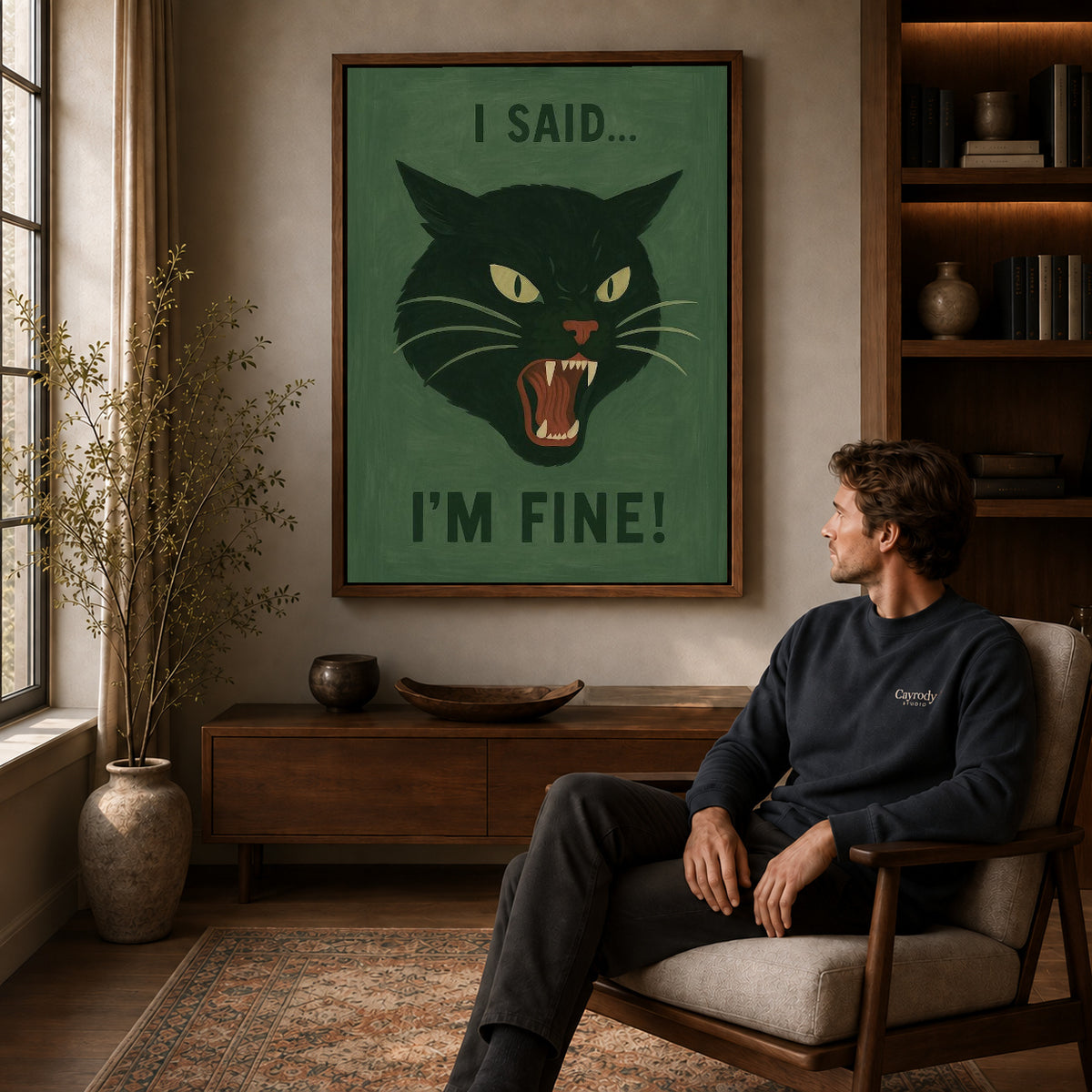 Grumpy Cat canvas art above a wooden console beside a seated man in a warm room.