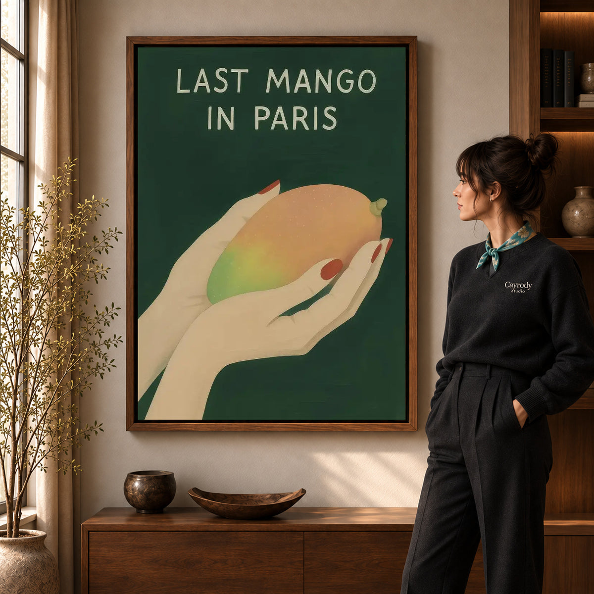 Walnut framed last mango canvas art shown beside a standing woman and a wooden console.