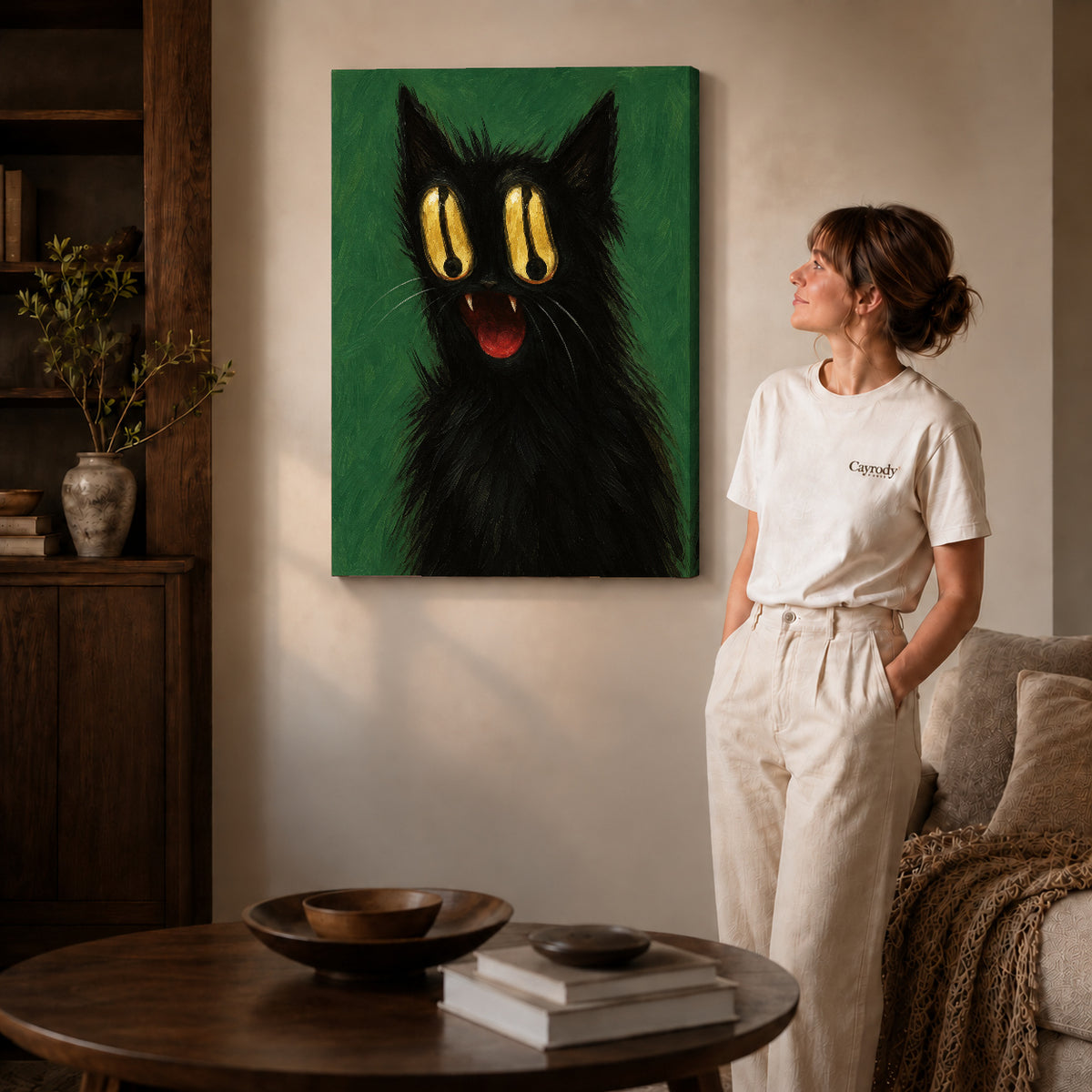 Golden Eyed Cat canvas art displayed as gallery wrapped canvas beside a woman in natural light.