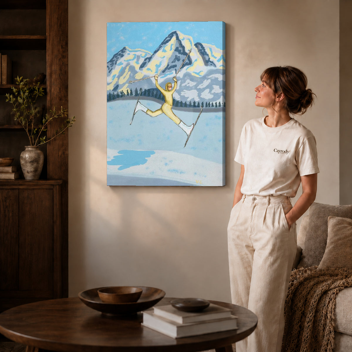 Gallery wrapped joyful skier canvas art with visible canvas edges beside a standing woman.