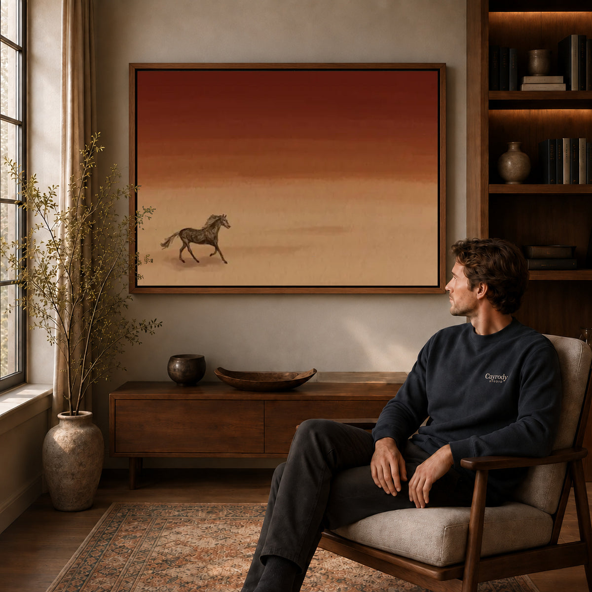 Desert Horse canvas art above a wooden console beside a seated man in a warm room.
