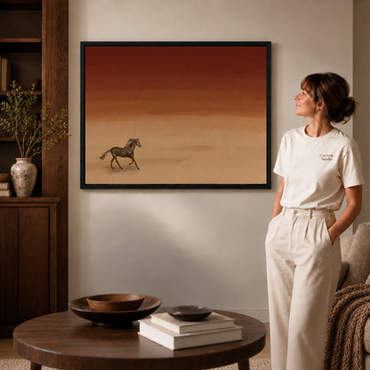 Desert Horse canvas art in a black frame above books in a welcoming living room.