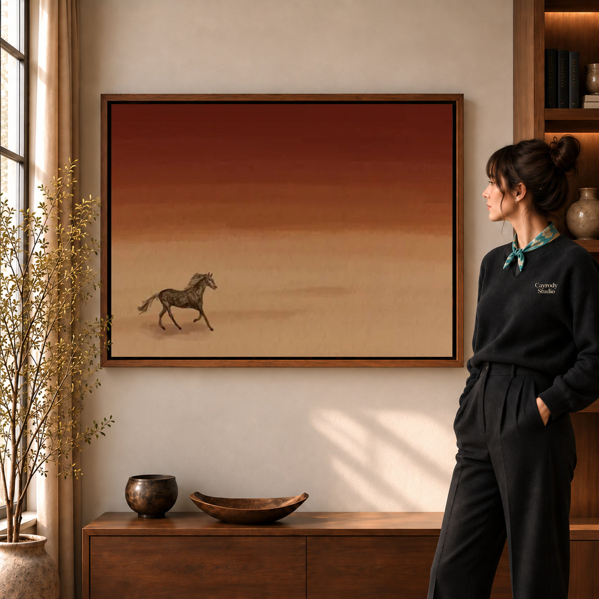 Walnut framed desert horse canvas art shown beside a standing woman and a wooden console.