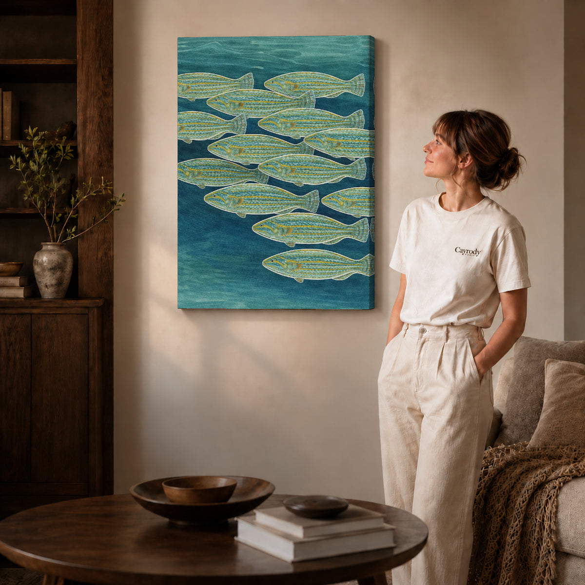 Gallery wrapped swimming fish canvas art with visible canvas edges beside a standing woman.