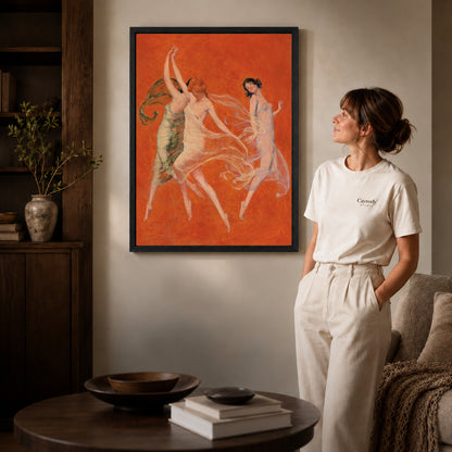 Black framed graceful dancers canvas art displayed beside a woman in a warm living room.