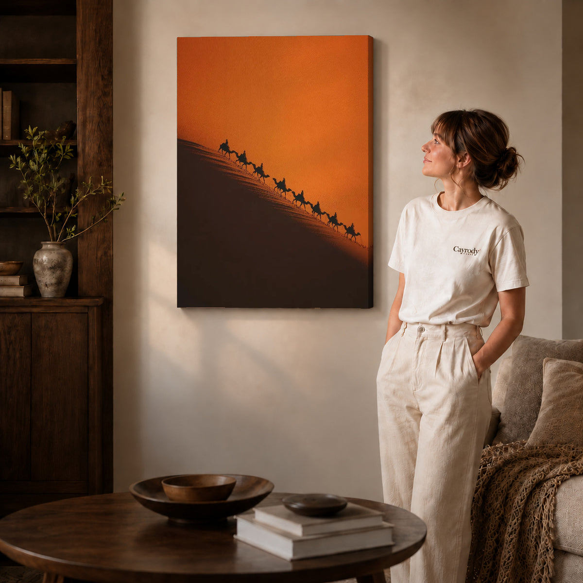 Desert Caravan canvas art displayed as gallery wrapped canvas beside a woman in natural light.