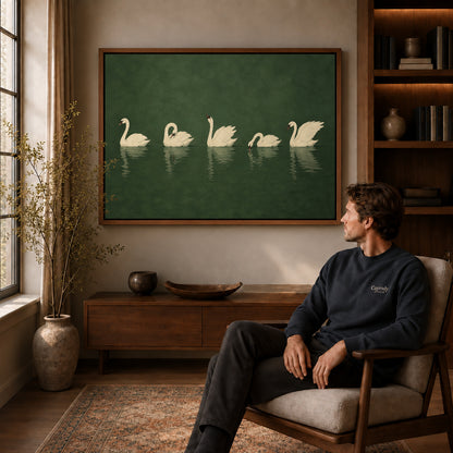 Quiet Swan Gathering canvas art above a wooden console beside a seated man in a warm room.