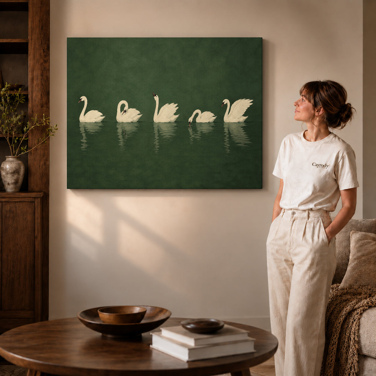 Quiet Swan Gathering canvas art displayed as gallery wrapped canvas beside a woman in natural light.