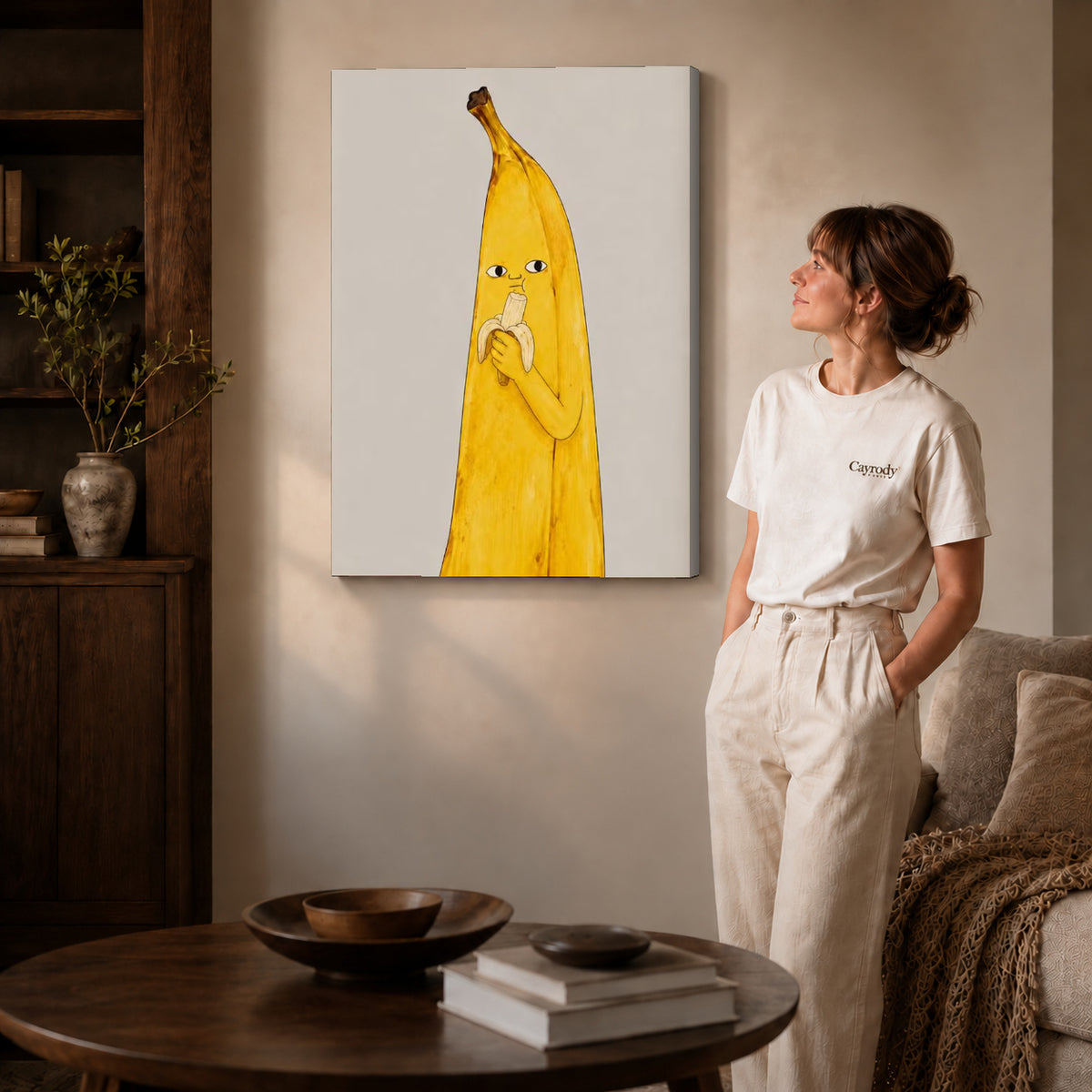 Gallery wrapped banana snack canvas art with visible canvas edges beside a standing woman.