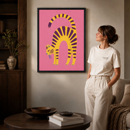 Arched Tabby canvas art in a black frame above books in a welcoming living room.