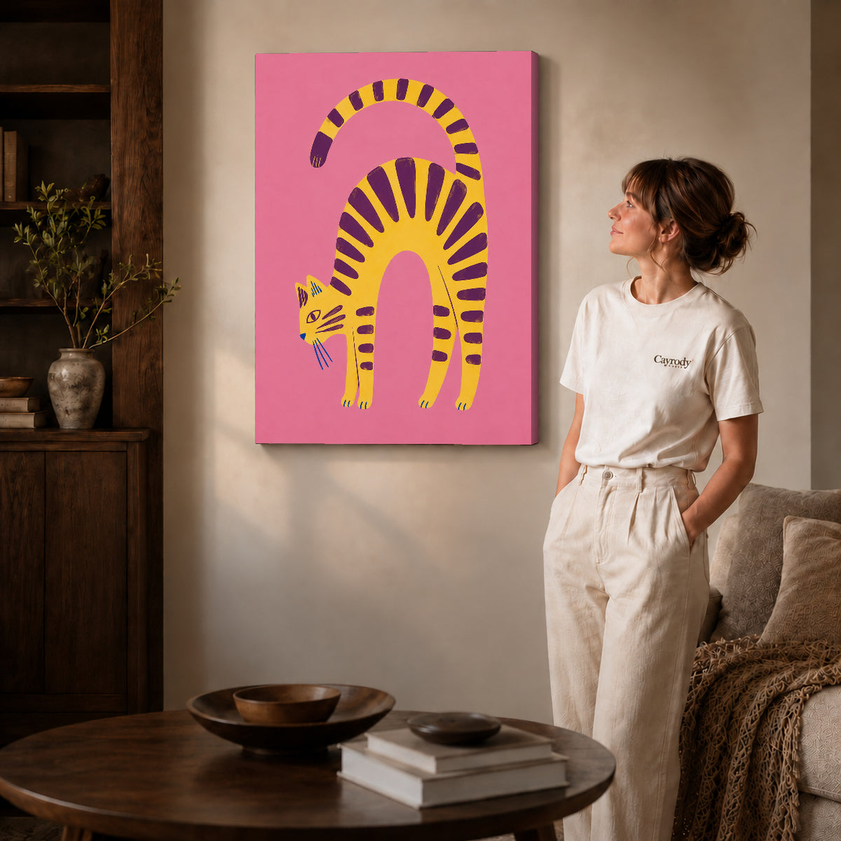 Gallery wrapped arched tabby canvas art with visible canvas edges beside a standing woman.