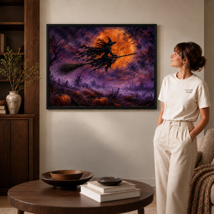 Witch Canvas Art inside a black frame in a softly lit living room with books.