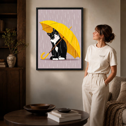 Black framed umbrella cat canvas art displayed beside a woman with natural light across the wall.