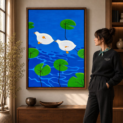 Duck Canvas Art in a walnut frame beside a standing woman and warm wooden furniture.