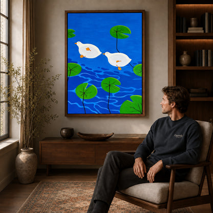 Duck Canvas Art displayed in a walnut frame above wooden furniture beside a seated man.