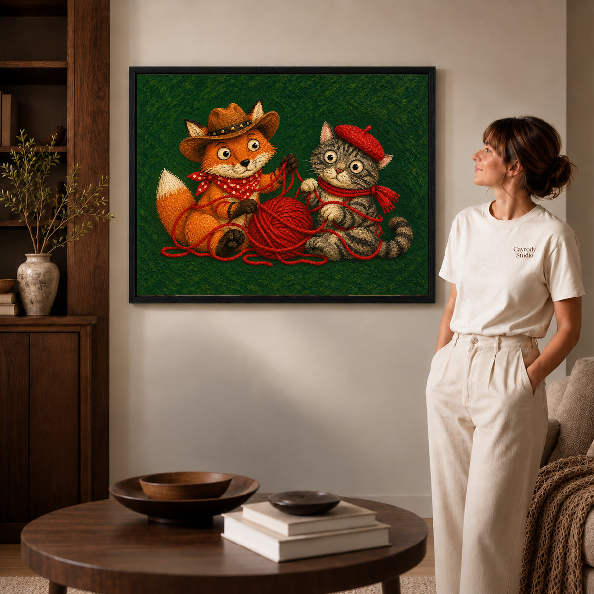Fox Cat Canvas Art inside a black frame in a softly lit living room with books.