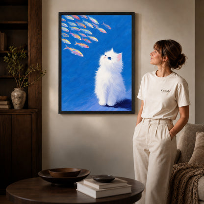 Kitten Canvas Art inside a black frame in a softly lit living room with books.