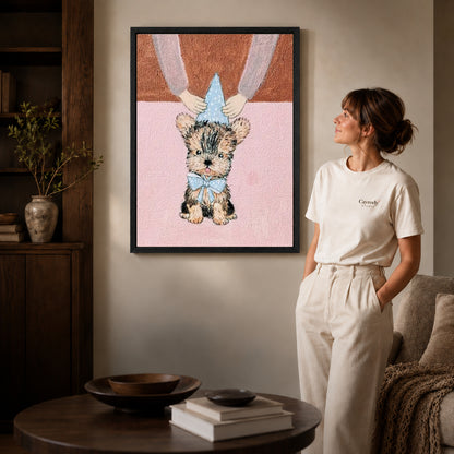 Black framed birthday puppy canvas art displayed beside a woman with natural light across the wall.