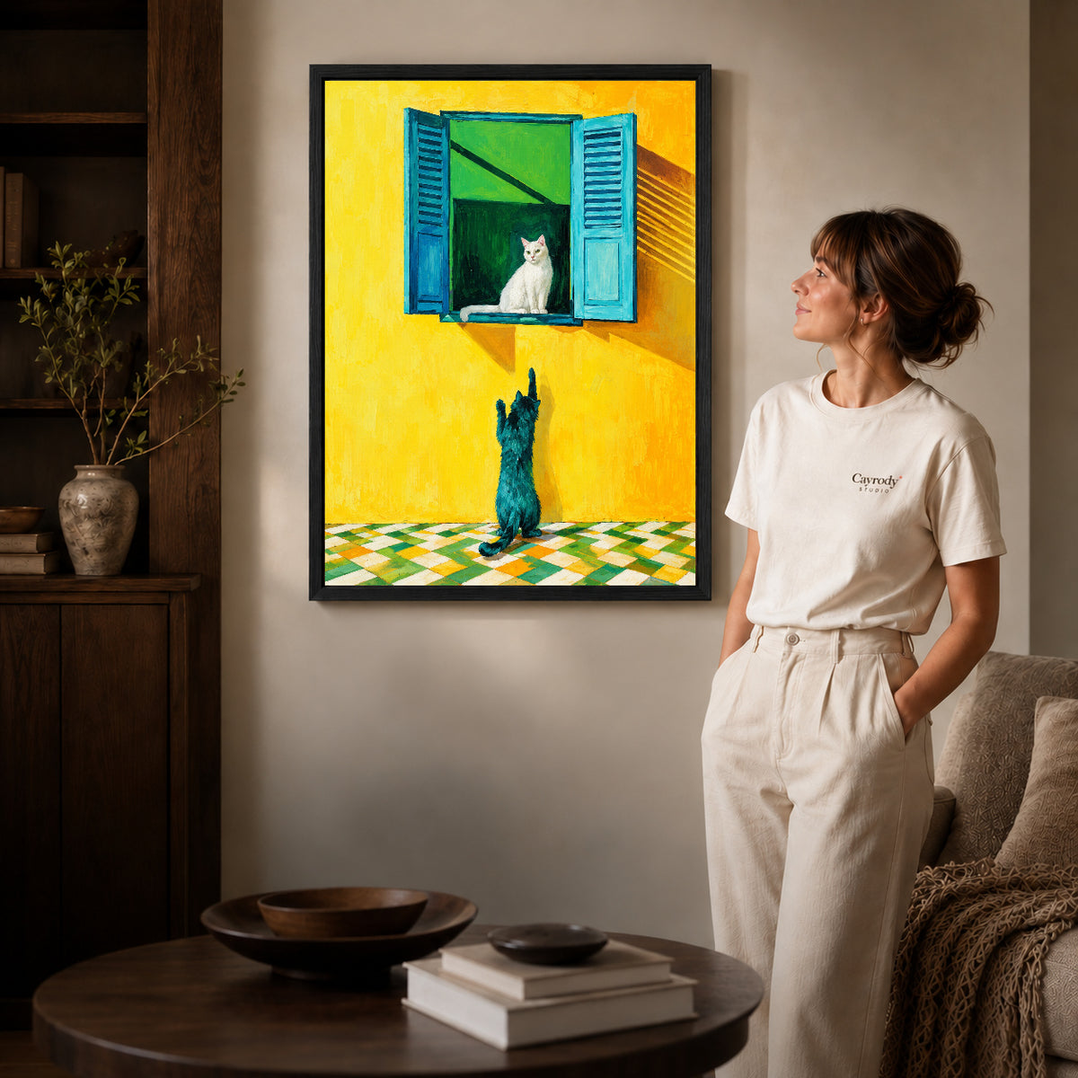 Black framed window cat canvas art displayed beside a woman with natural light across the wall.
