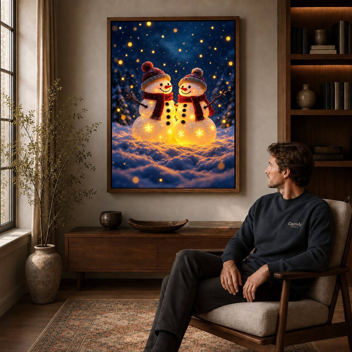 Snowman Canvas Art displayed in a walnut frame above wooden furniture beside a seated man.